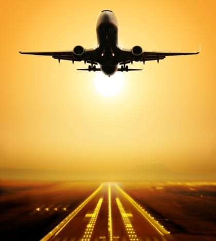 take-off runway passenger plane fly up over take-off runway from airport at sunset