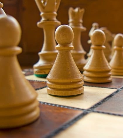 Wooden white and brown chessboard close-up Wooden white and brown chessboard close-up