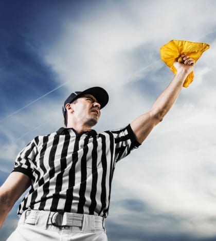 A football referee holding a yellow flag against the sky.  He is calling the penalty. 

[url=http://www.istockphoto.com/search/lightbox/9786766][img]http://dl.dropbox.com/u/40117171/sport.jpg[/img][/url]