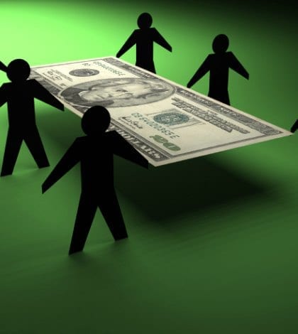 Paper people moving a $20 bill Paper people moving a $20 bill