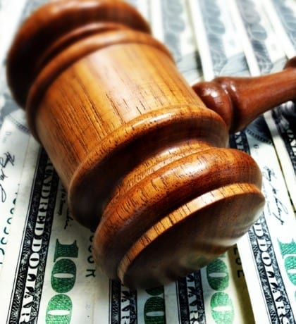 gavel and cash money A court gavel on 100 bills - legal concept
