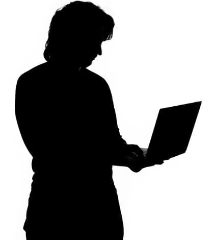 Silhouette of a man holding laptop Silhouette of a man holding laptop