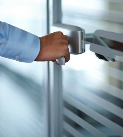 Male hand opening office door Male hand opening office door