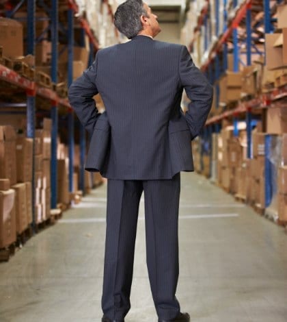 Rear View Of Manager In Warehouse Rear View Of Manager In Warehouse