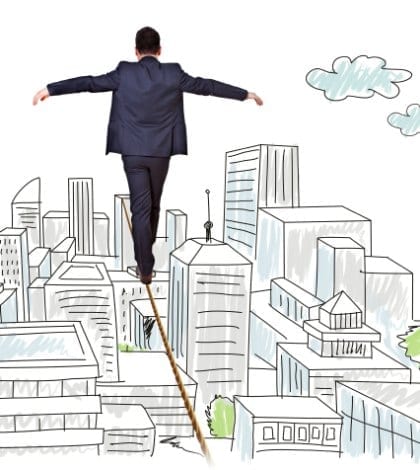 businessman balancing on tightrope city