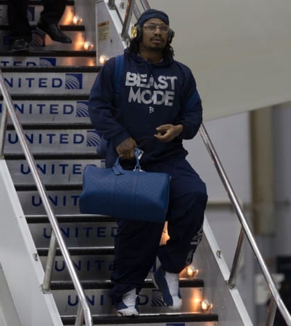 NEWARK, NJ - JANUARY 26, 2014: Seattle Seahawks Marshawn Lynch arrives on Delta flight 8872 charter Boeing 767-300 plane at Newark Liberty International Airport for the NFL Super Bowl XLVIII football game NEWARK, NJ - JANUARY 26, 2014: Seattle Seahawks Marshawn Lynch arrives on Delta flight 8872 charter Boeing 767-300 plane at Newark Liberty International Airport for the NFL Super Bowl XLVIII football game