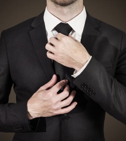businessman correcting tie fashion businessman in black suit correcting his black tie fashion