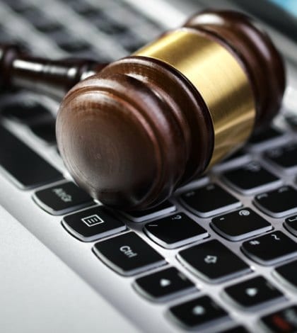 Gavel on laptop computer keyboard concept for online internet auction or legal assistance