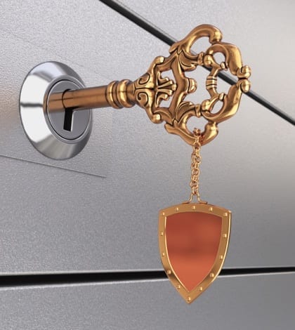 Key in the safe deposit box Key with trinket in form of shield in the safe deposit box