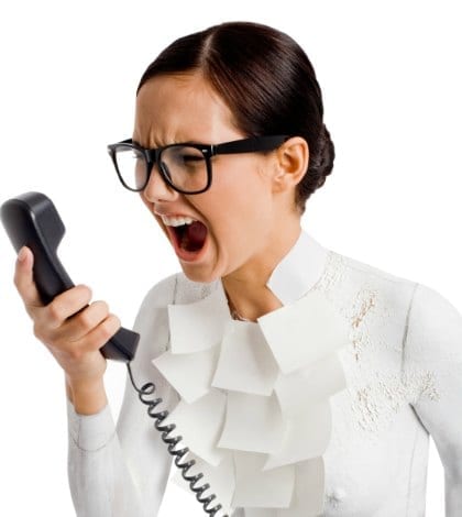 Photo of angry female holding phone receiver and shouting into it