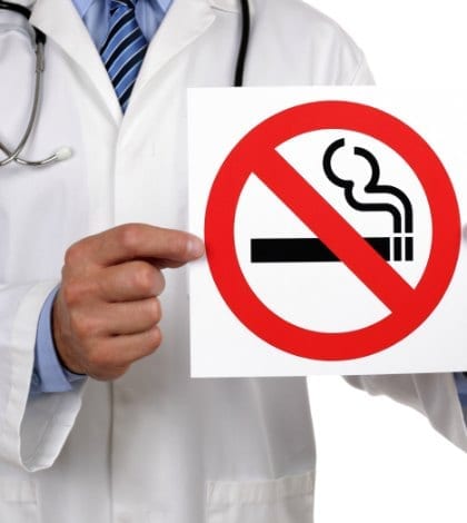 Doctor advice holding a no smoking sign