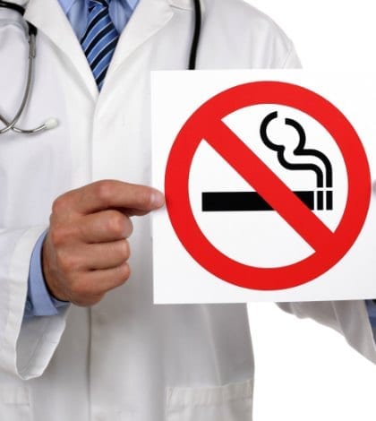 Doctor advice holding a no smoking sign Doctor advice holding a no smoking sign