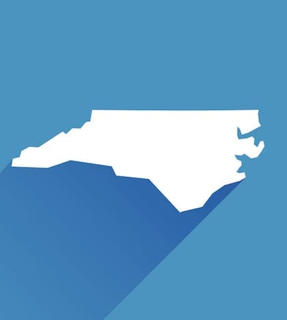 Vector illustration of a blue North Carolina state icon with shadow.