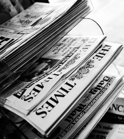 Stack of Newspapers. London - England. Black And White London,United Kingdom - August 27th 2013:stack of newspapers in a kiosk,London,United Kingdom.