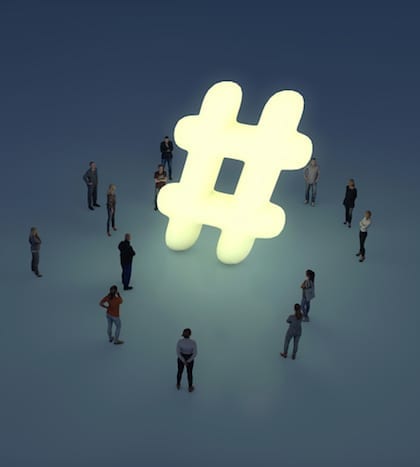 Group of people gathering around a glowing hashtag symbol