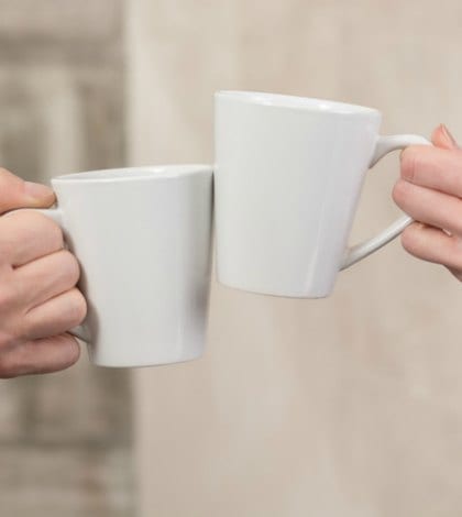 toast clink coffee cups 527523986 420 People holding cups of delicious coffee in office. Close-up of porcelain cups represented all together. Aroma concept.
