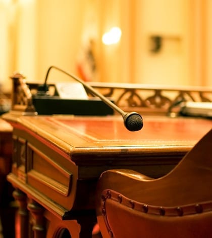 A microphone on the antique desk of a California State Senator. In the chambers of the California Senate in Sacramento.