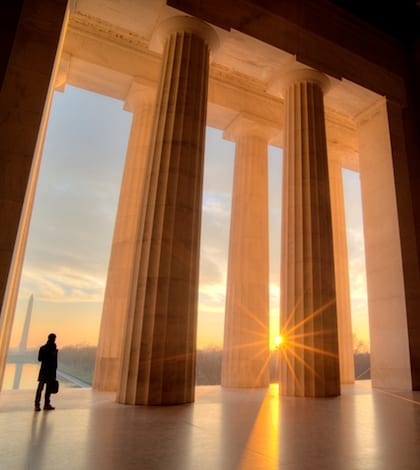 Businessman inside Lincoln Memorial at sunrise