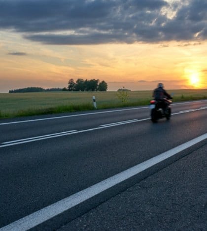Motion blur motorcycle riding on asphalt road towards the horizon in rural landscape at sunset. Red car in the distance.
Keywords: motorcycle, motorbike, drive roadster, motorcyclist, car, vehicle, automobile, transport, traffic, transit, transportation, conveyance, vehicular, drive, ride, travel, tour, trip, motion blur, highway, motorway, road, asphalt, perspective, landscape, countryside, nature, scenery, meadow, grass, green, field, rural, tree, horizon, summer, sky, cloud, sun, sunset, sundown, sunrise, golden, orange, yellow, dusk, twilight, darkness, dawn, daybreak