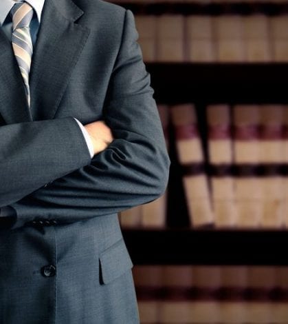 Businessman in front of books Arbitration