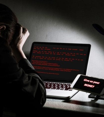 Young lady frustrated, confused and headache by malware ransomware attack on desktop screen Young lady frustrated, confused and headache by malware ransomware attack on desktop screen, notebook and smartphone, cyber attack internet security concept