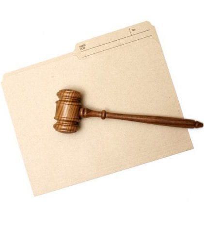 Legal folder and judge's gavel A gavel and folder represent legal documents.