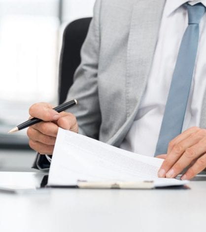 Businessman signing contract Senior analyst managing business accounts. Close up of a senior businessman hands checking final report before submission. Close up of hands of leadership signing business contract.