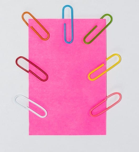 Colorful paperclips and post it on white background isolated