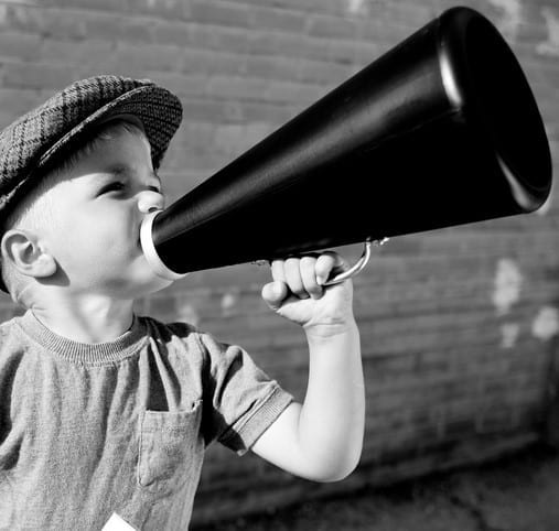 Attention! (b&w) Items for sale! Words to be heard! A young salesman or director makes his ideas known. Look below for the color version.