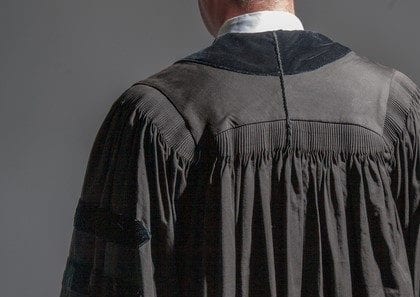 The Judge walks away Back view of a young judge
