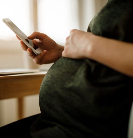 Pregnant woman using mobile phone
