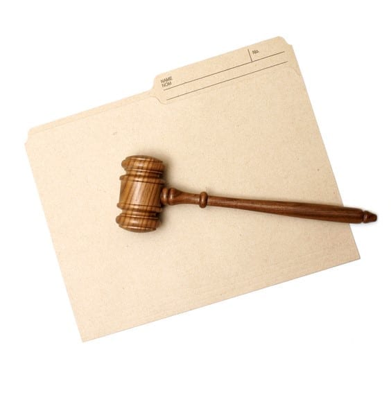 A gavel and folder represent legal documents.