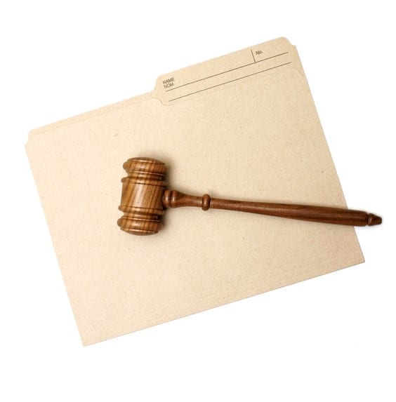 Legal folder and judge's gavel A gavel and folder represent legal documents.