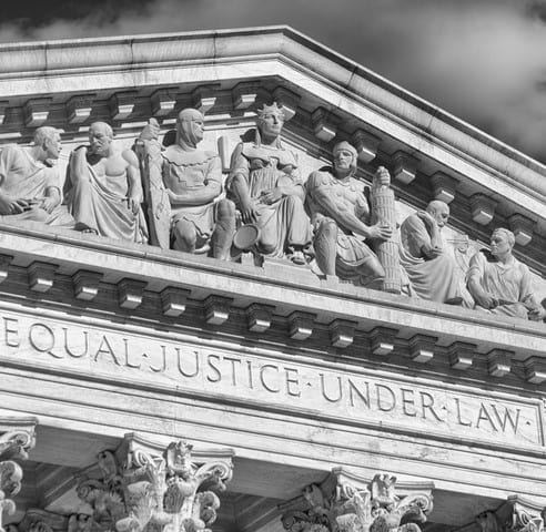 Close-up in black and white of the message "Equal Justice Under Law" inscribed in the classically detailed US Supreme Court building in Washington, DC, USA