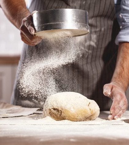 hands of baker's male knead dough hands of the baker's male knead dough