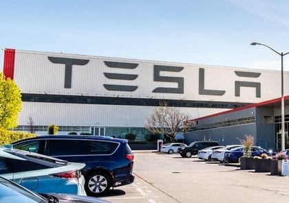April 12, 2019 Fremont / CA / USA - Exterior view of Tesla Factory located in East San Francisco bay area, California; Tesla logo displayed on the exterior wall