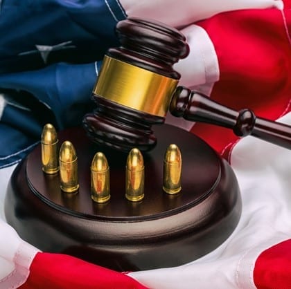 gavel and gun cartridge on a American Constitution with USA flag. ideal for websites and magazines layouts
