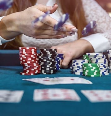 Female hands with playing cards and poker chips Female hands with playing cards and poker chips