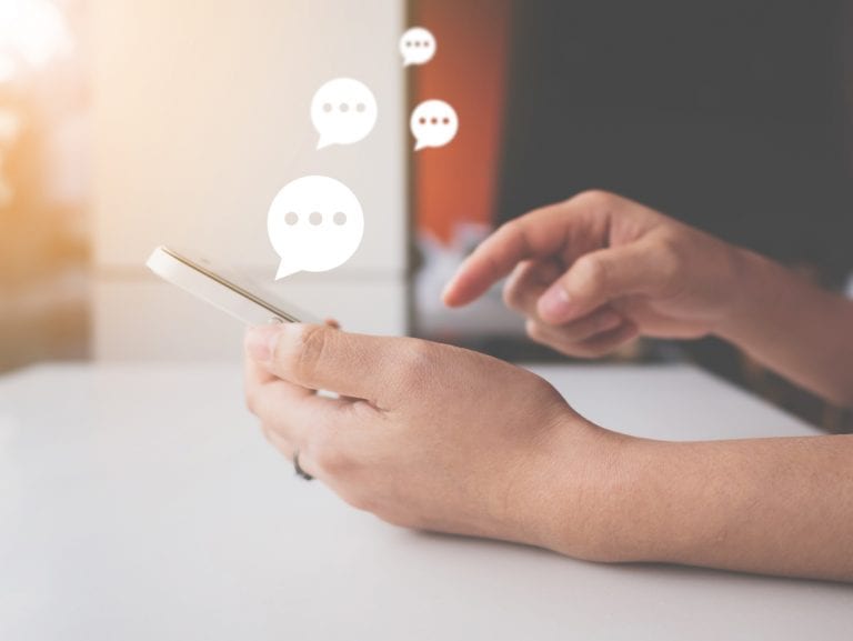Hand of woman typing text on mobile smartphone. Online live chat chatting on application communication digital media website and social network Hand of woman typing text on mobile smartphone. Online live chat chatting on application communication digital media website and social network