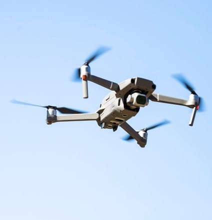 Flying Drone in the blue sky, background with copy space, full frame horizontal composition