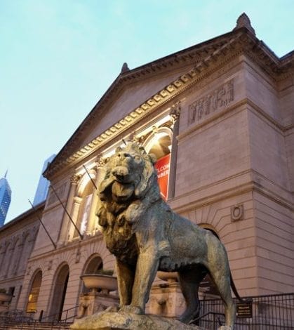 "Chicago, Illinois, USA - March 25, 2012: Art Institute of Chicago seen evening time with the sculpture of lion and the main entrance from Michigan Avenue. Art Institute of Chicago. The Museum opened in 1879 and moved to the present location at 111 Michigan Avenue in 1893."