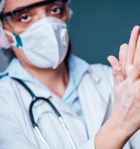 Doctor cleaning and disinfecting her hands in hospital Germany, Adult, Adults Only, COVID-19, Care