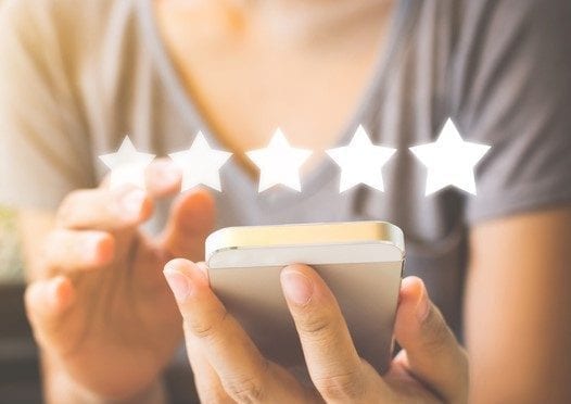 Customer service experience and business satisfaction survey. Woman hand using smart phone with icon five star symbol to increase rating of company concept Customer service experience and business satisfaction survey. Woman hand using smart phone with icon five star symbol to increase rating of company concept