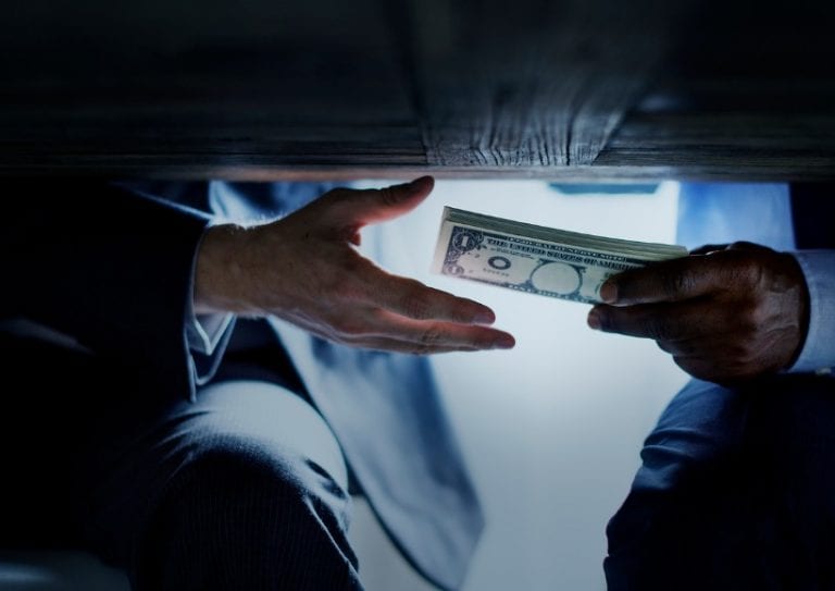 hands-passing-money-under-table-corruption-bribery-picture-id851497470