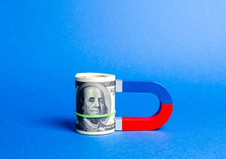 the-magnet-is-magnetized-to-dollars-bundle-attracting-money-and-for-picture-id1163910581 the-magnet-is-magnetized-to-dollars-bundle-attracting-money-and-for-picture-id1163910581