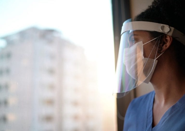 nurse-with-protective-face-mask-looking-through-window-at-hospital-picture-id1250095373 nurse-with-protective-face-mask-looking-through-window-at-hospital-picture-id1250095373