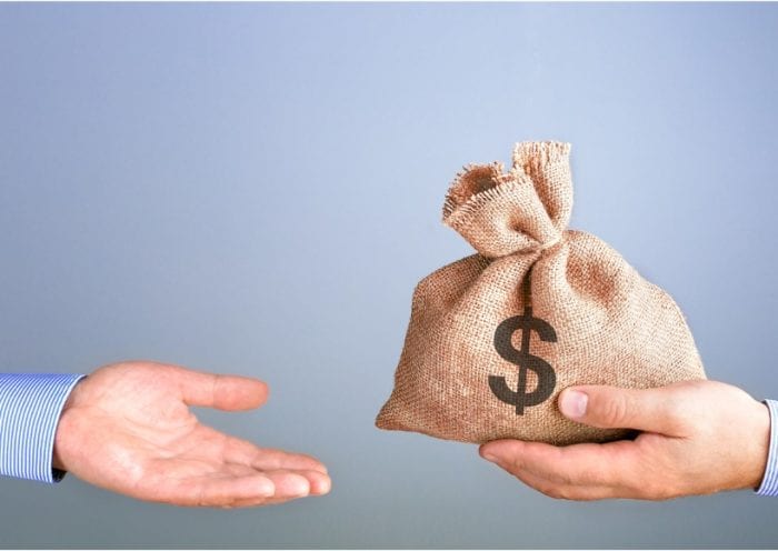 man-holds-gives-a-bag-of-money-in-hand-like-a-bonus-businessman-bag-picture-id1185417262 (1)