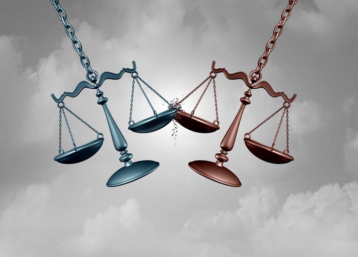 Legal battle lawsuit concept as two justice scales hitting each other as a justice court fight symbol representing a lawyer or attorney representation services with 3D illustration elements.