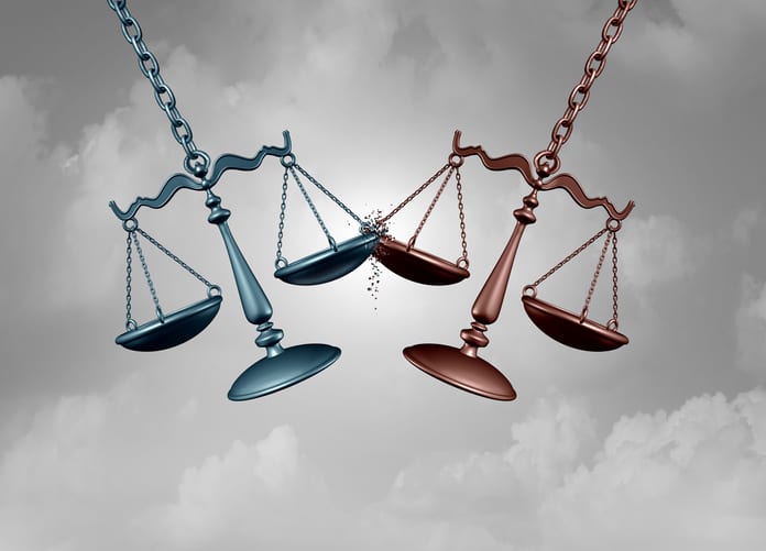 Legal BattleAnd Lawsuit Legal battle lawsuit concept as two justice scales hitting each other as a justice court fight symbol representing a lawyer or attorney representation services with 3D illustration elements.