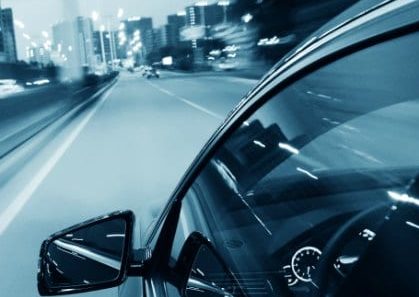 Car driving through the city at night. Car driving through the city at night.
